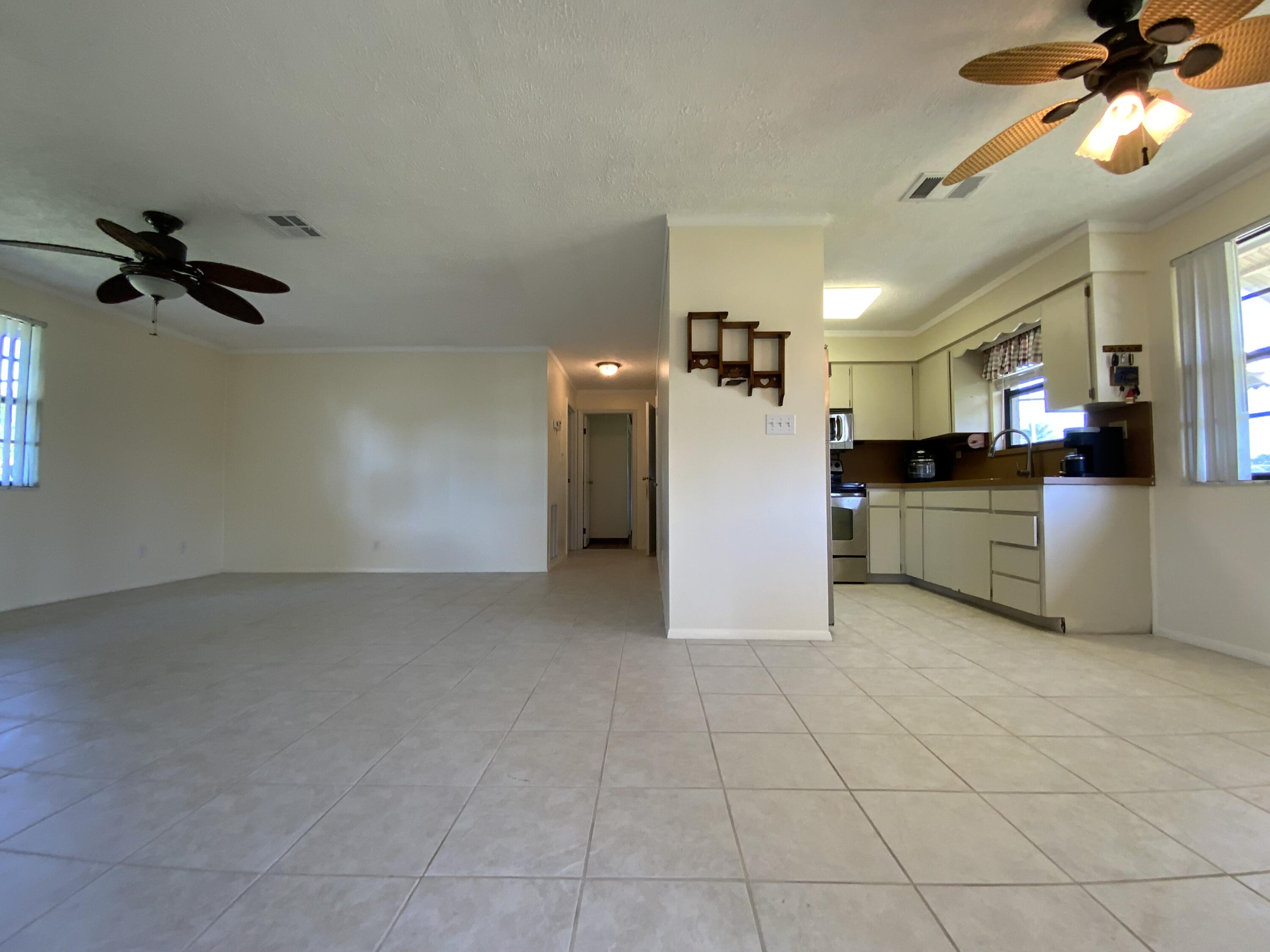 1095 Chobee Loop Okeechobee, FL 34974 - Photo 44 of 46 a view of a kitchen with a sink and a refrigerator