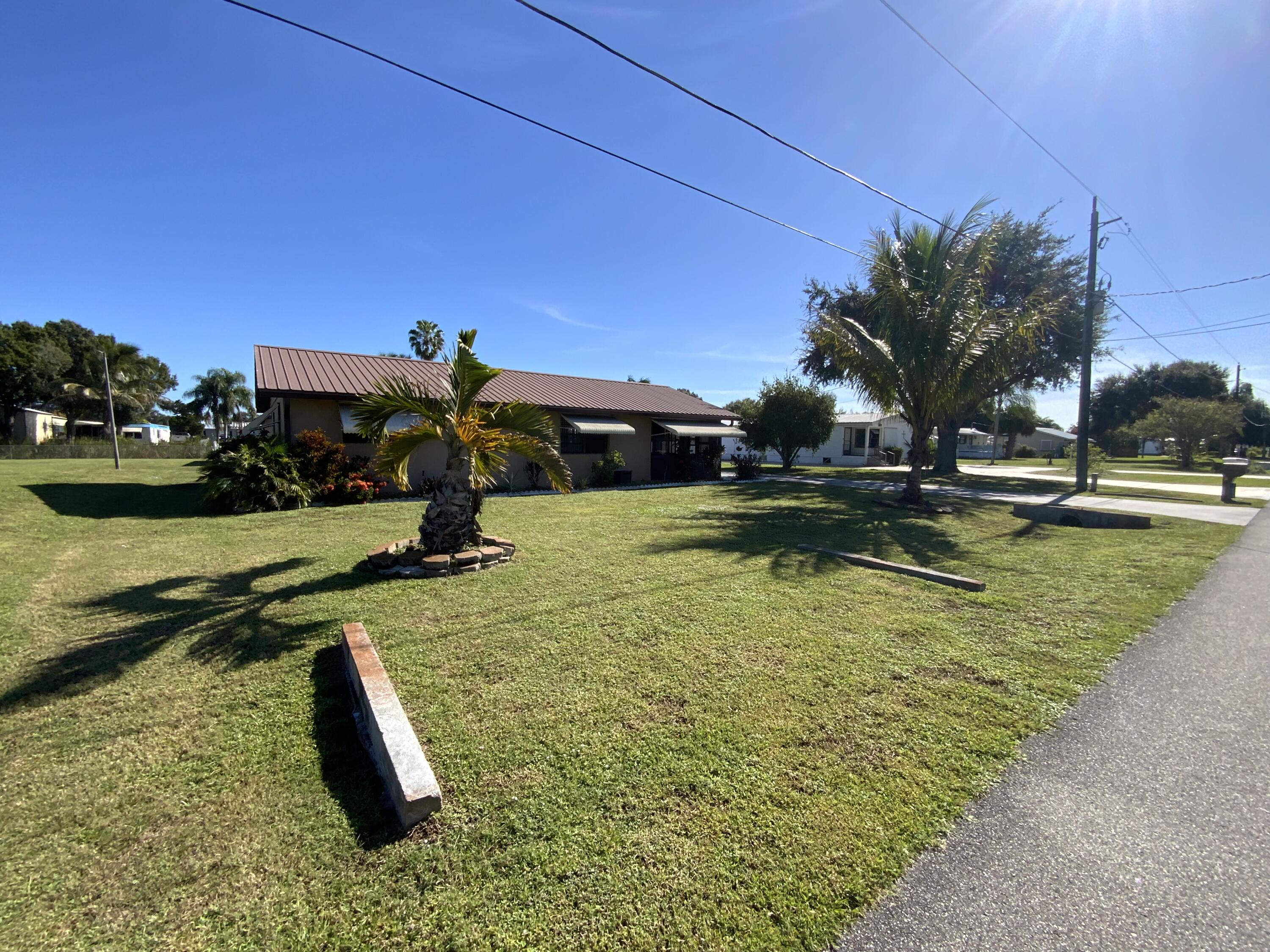1095 Chobee Loop Okeechobee, FL 34974 - Photo 6 of 46 a view of a swimming pool with a yard