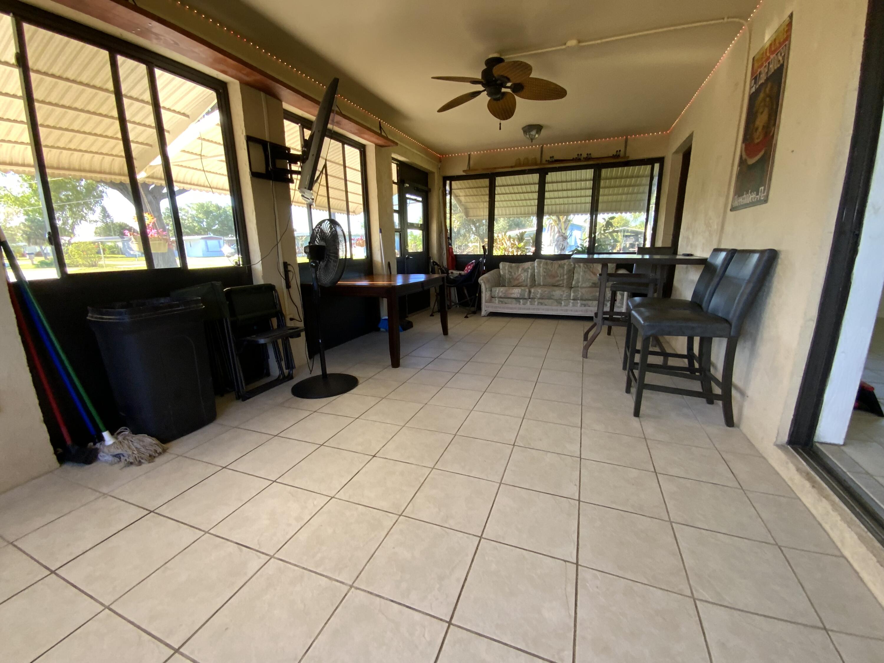 1095 Chobee Loop Okeechobee, FL 34974 - Photo 9 of 46 a living room with furniture and a flat screen tv