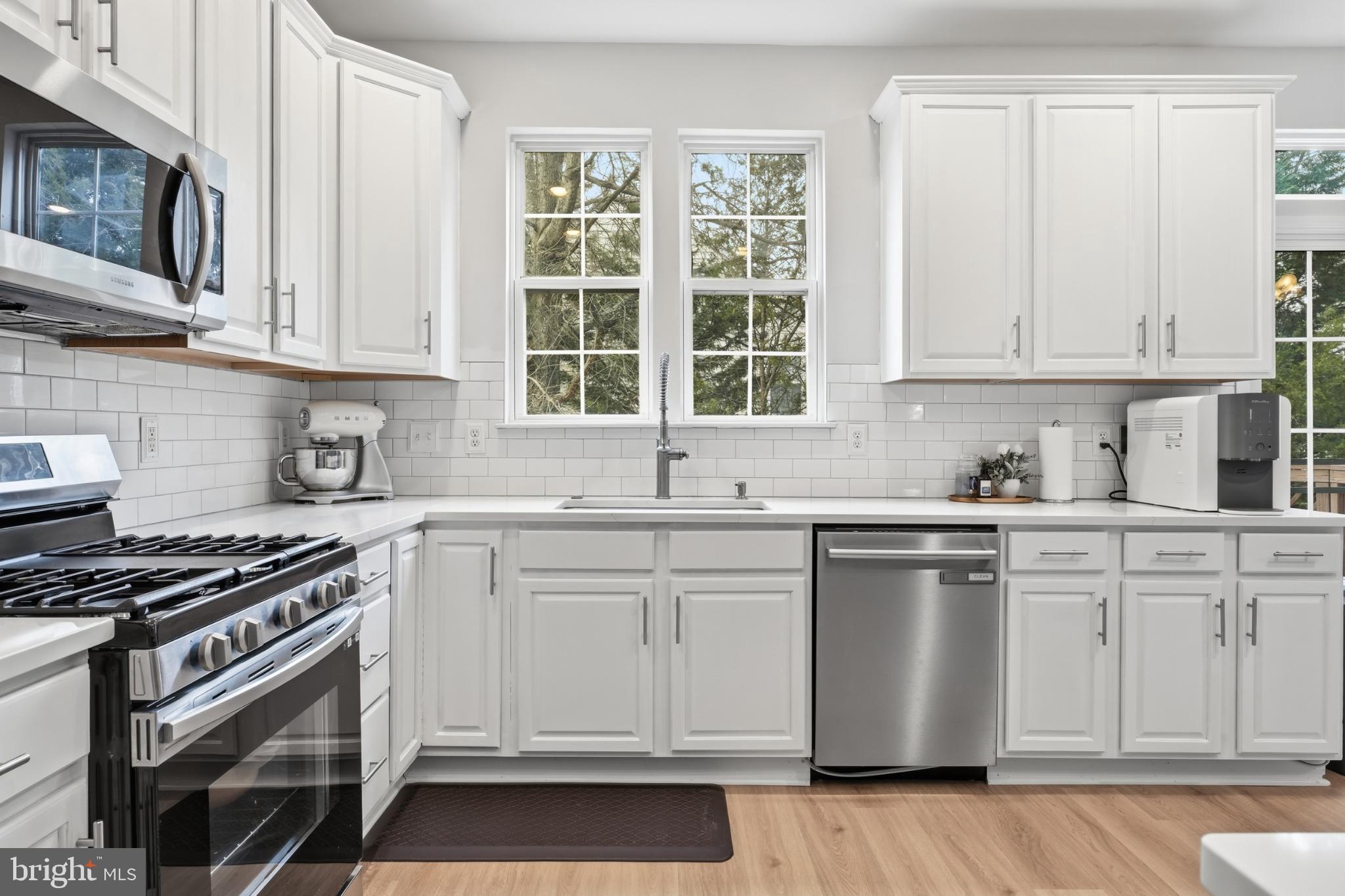 13993 Sawteeth Way Centreville, VA 20121 - Photo 12 of 44 a kitchen with stainless steel appliances granite countertop a stove a sink and a microwave