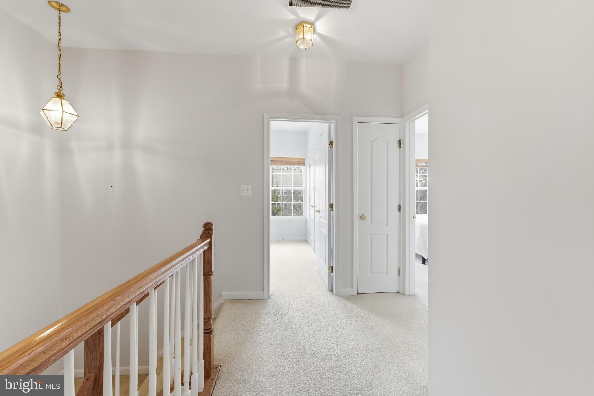13993 Sawteeth Way Centreville, VA 20121 - Photo 19 of 44 a view of a hallway with wooden floor and staircase