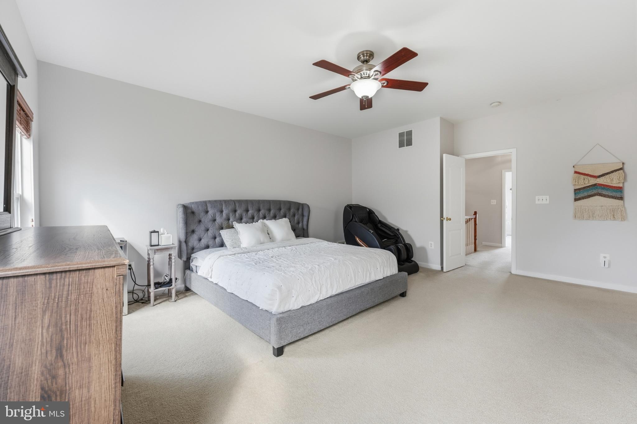 13993 Sawteeth Way Centreville, VA 20121 - Photo 21 of 44 a spacious bedroom with a bed and a chandelier