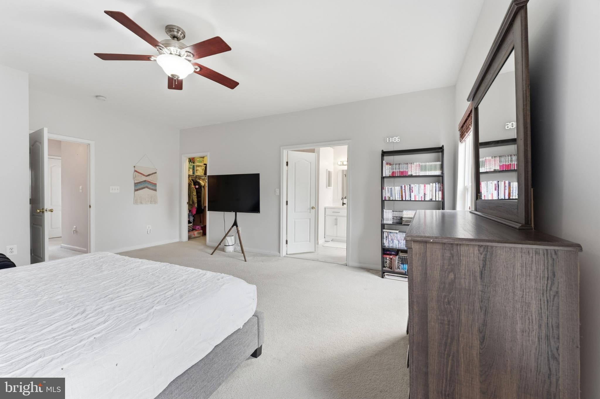 13993 Sawteeth Way Centreville, VA 20121 - Photo 22 of 44 a bedroom with a bed and a flat screen tv