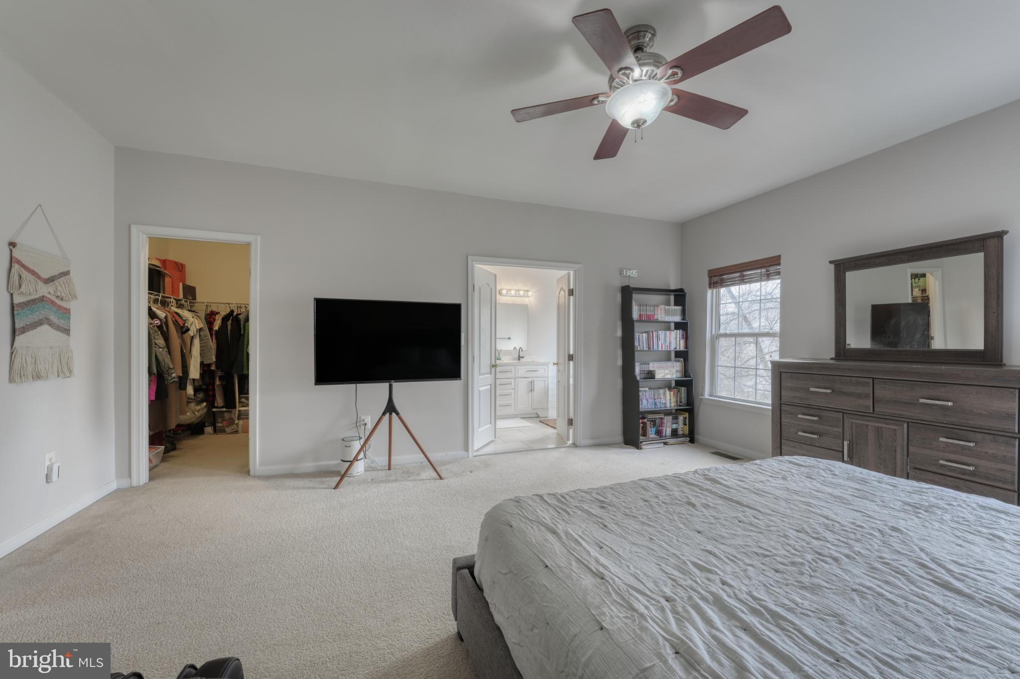 13993 Sawteeth Way Centreville, VA 20121 - Photo 23 of 44 a bedroom with a bed and a flat screen tv