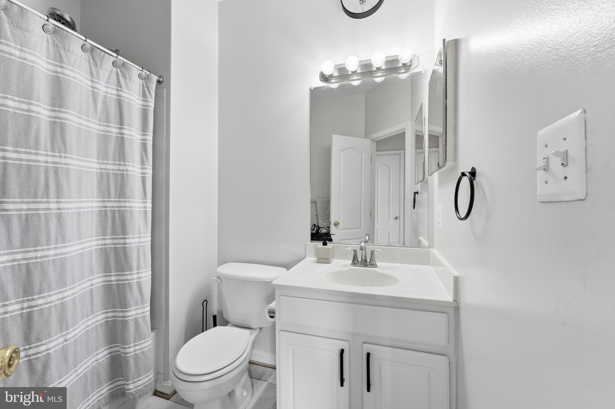 13993 Sawteeth Way Centreville, VA 20121 - Photo 31 of 44 a bathroom with a sink a toilet and shower