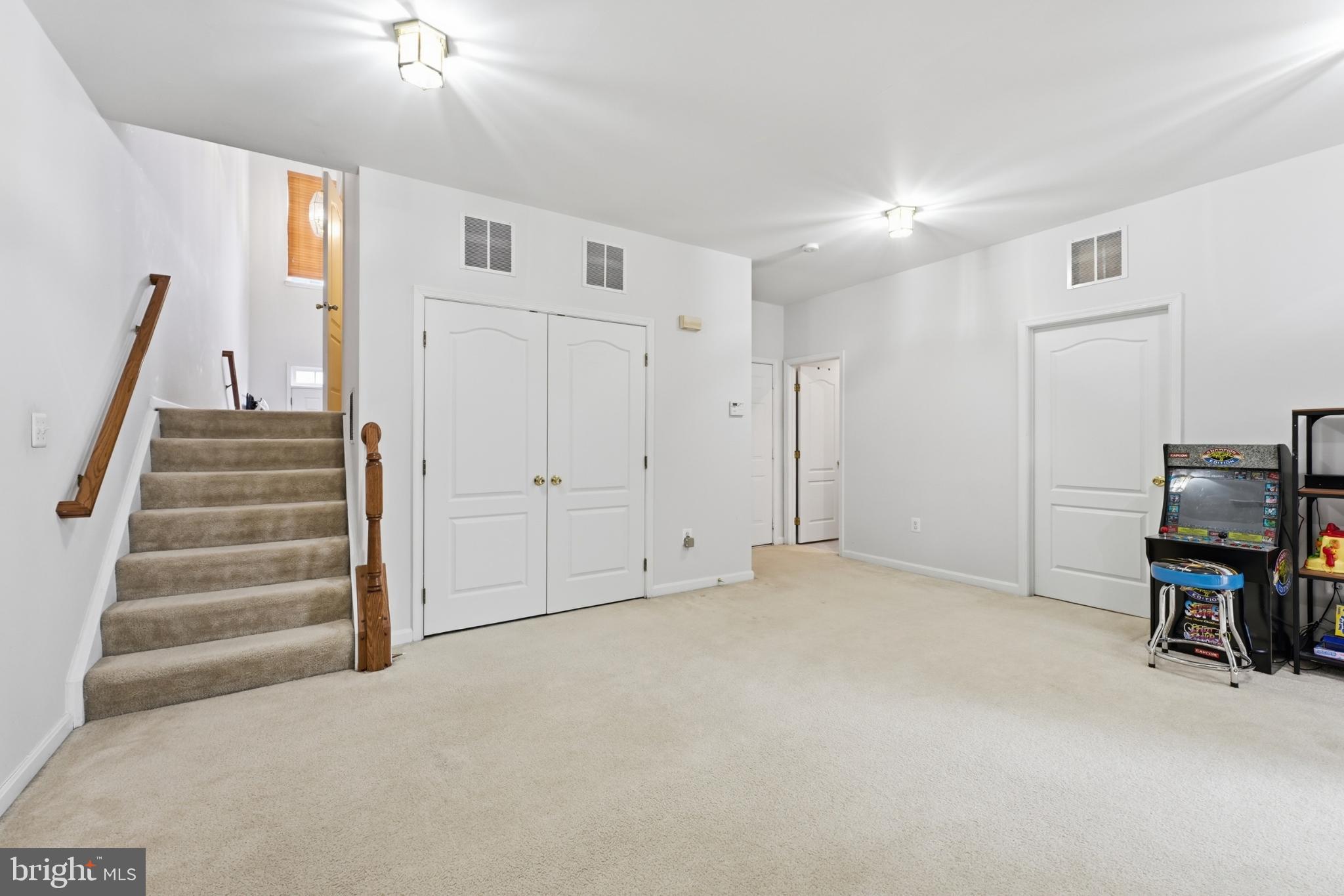13993 Sawteeth Way Centreville, VA 20121 - Photo 32 of 44 a view of an empty room with stairs and a chandelier fan