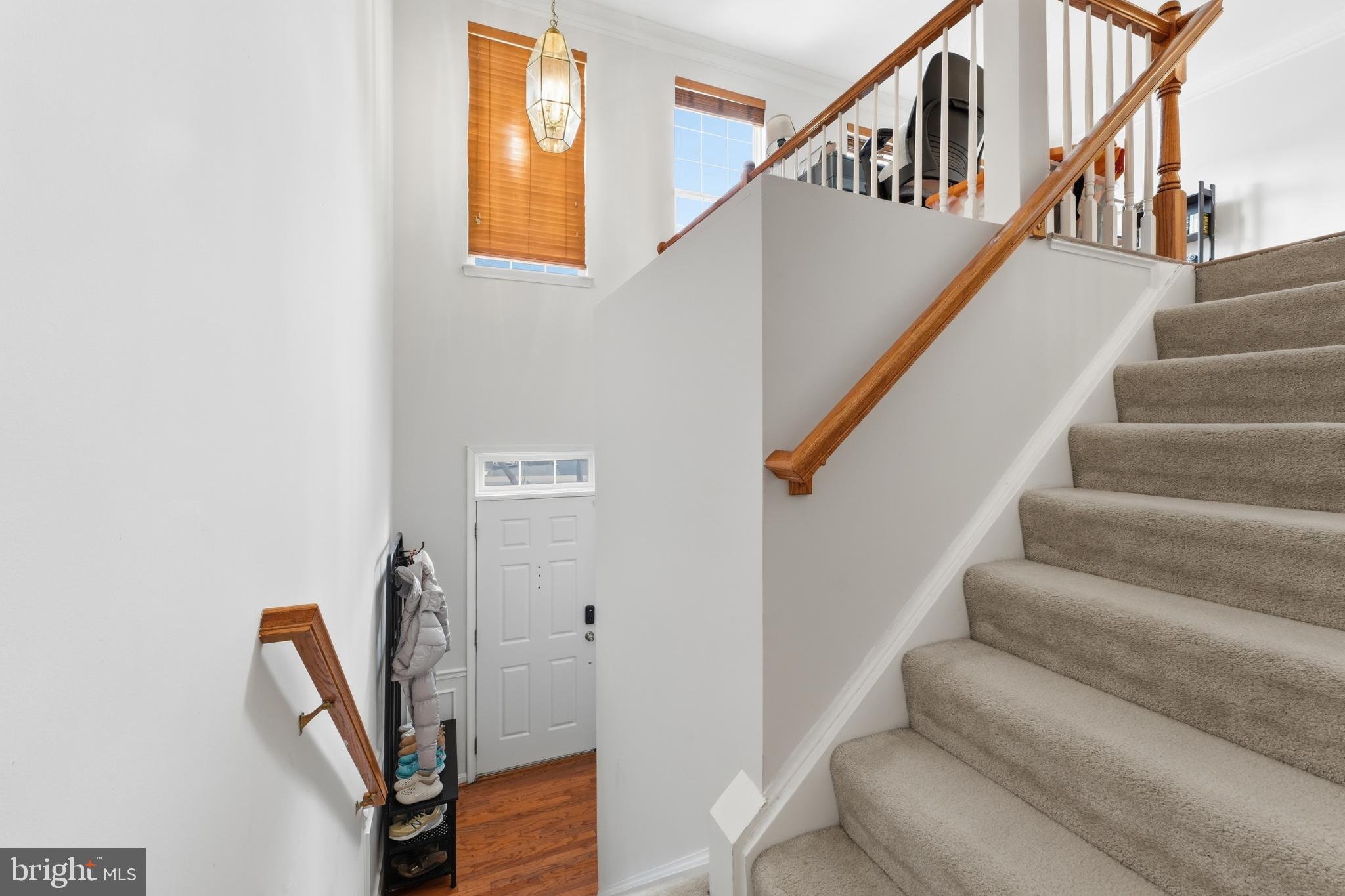 13993 Sawteeth Way Centreville, VA 20121 - Photo 4 of 44 a view of staircase with lots of frames on wall