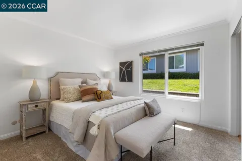 a bedroom with a bed and lamp