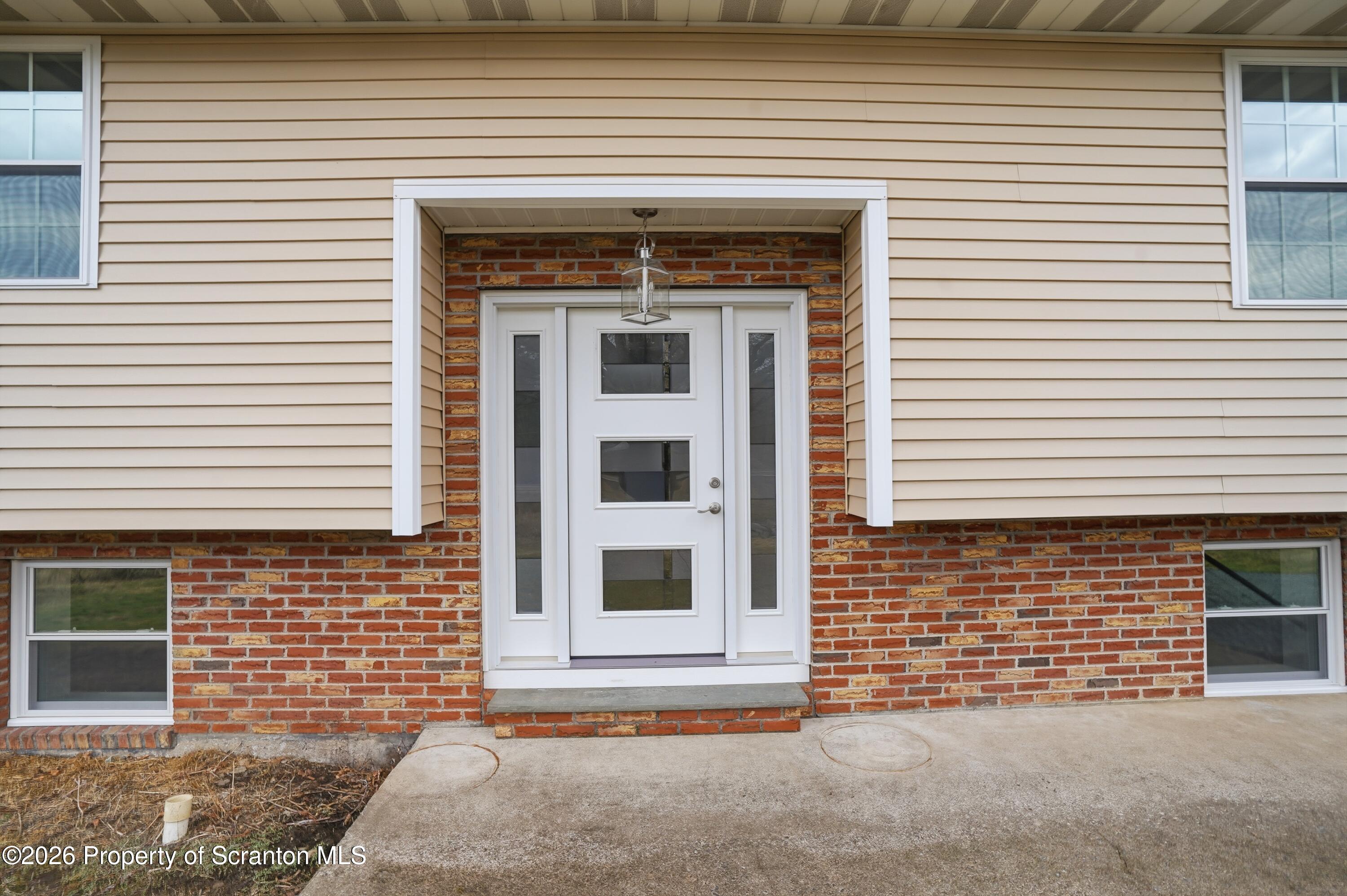 16204 Highway 407 Factoryville, PA 18419 - Photo 11 of 74 a front view of a house with large windows