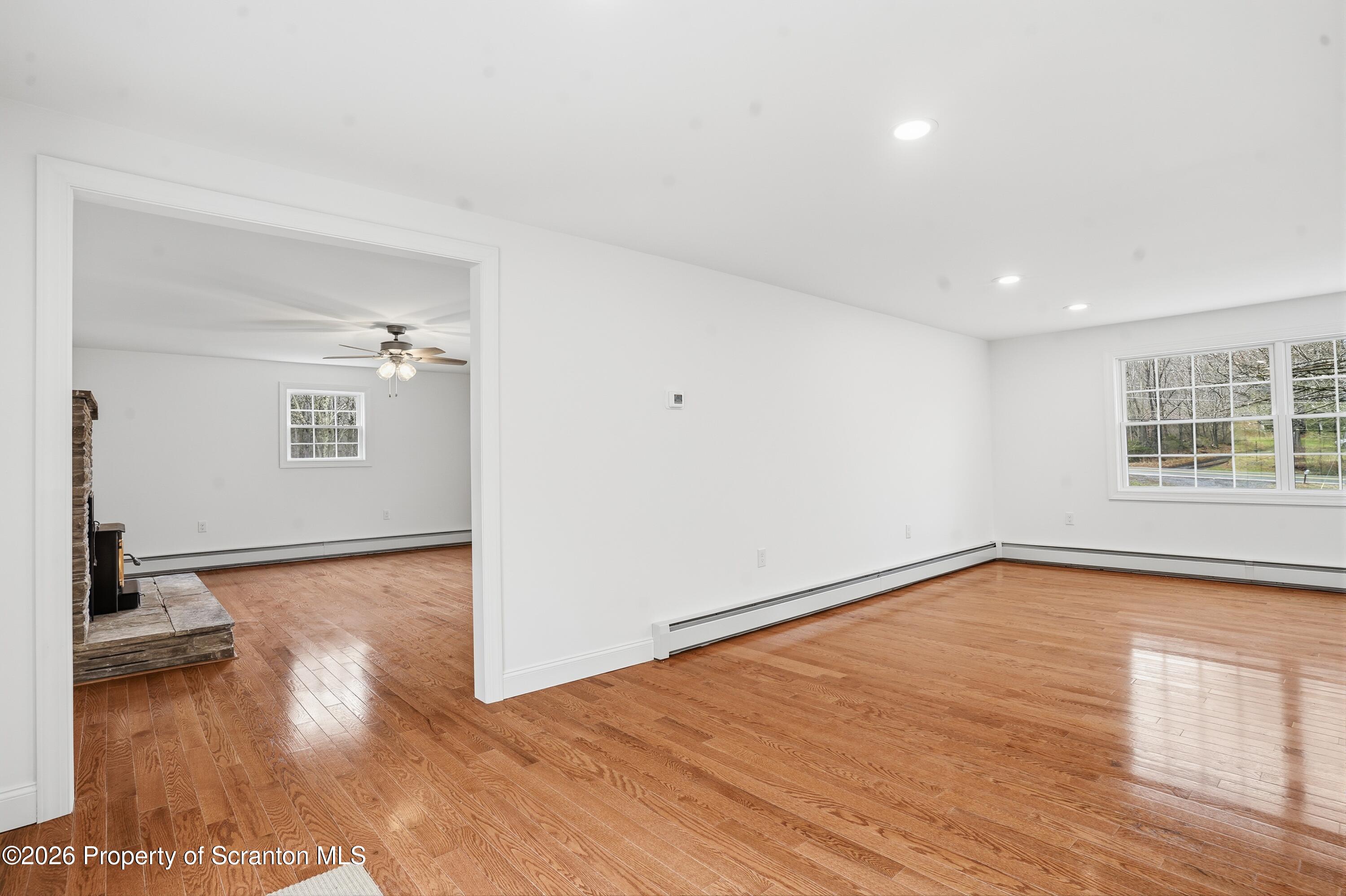 16204 Highway 407 Factoryville, PA 18419 - Photo 20 of 74 a view of a big room with wooden floor and windows