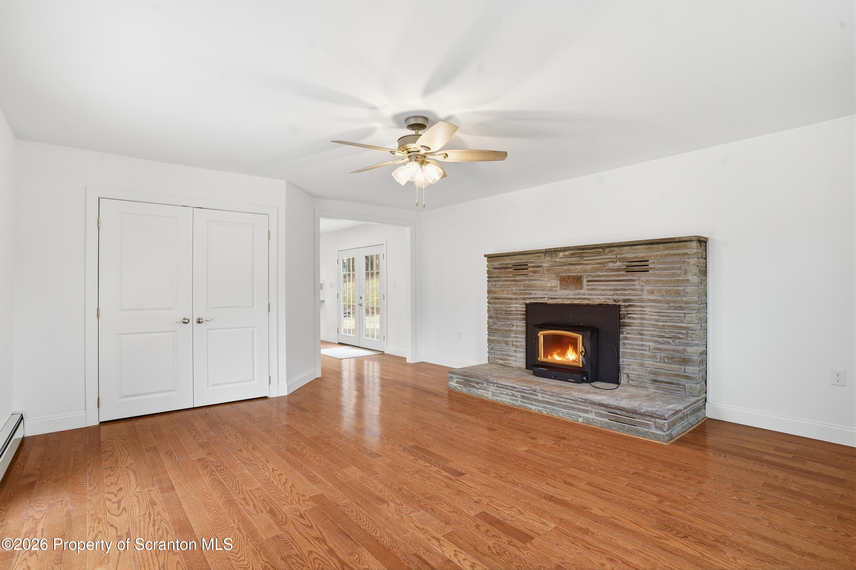 16204 Highway 407 Factoryville, PA 18419 - Photo 23 of 74 a view of a livingroom with a fireplace a ceiling fan and a fireplace