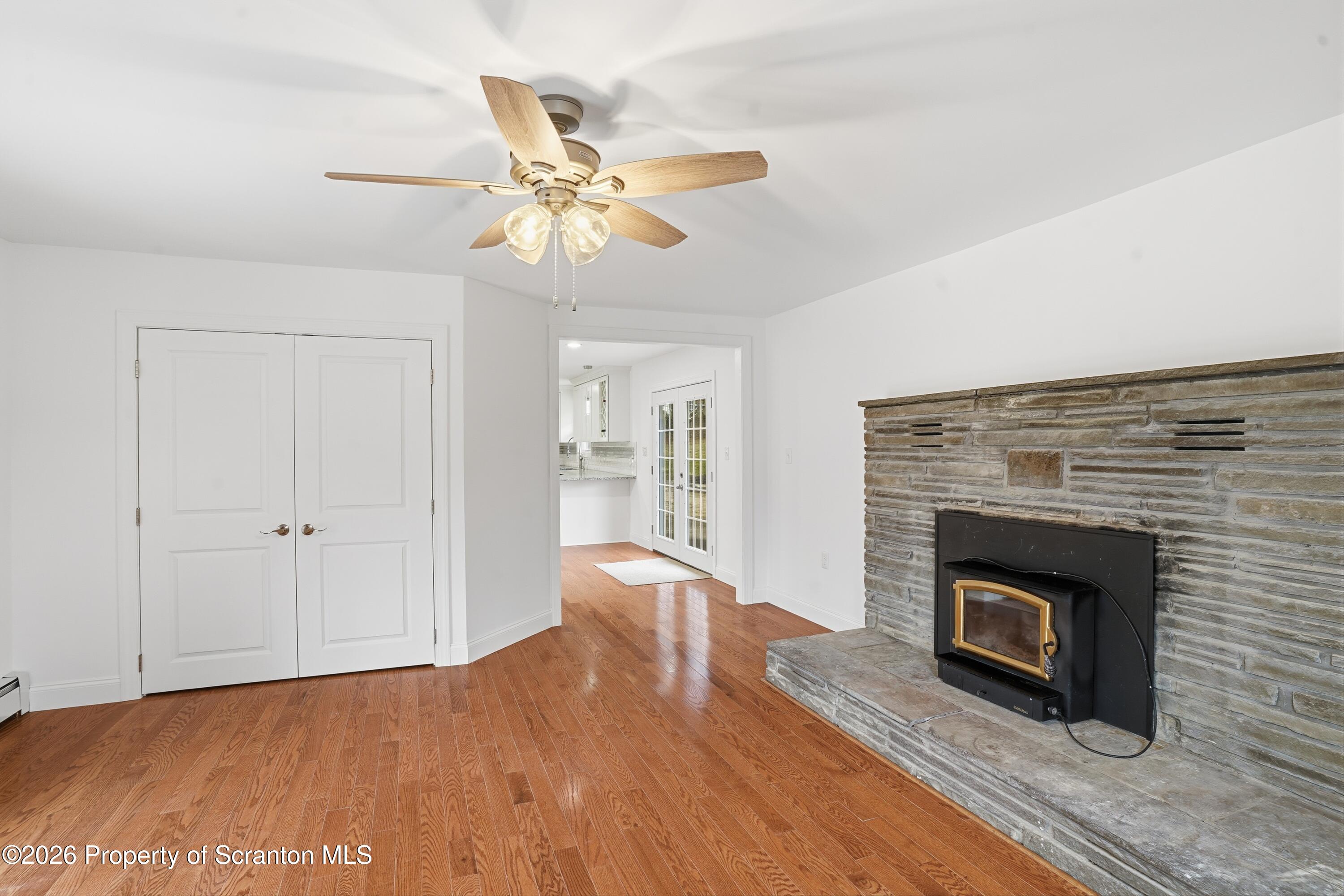 16204 Highway 407 Factoryville, PA 18419 - Photo 29 of 74 a view of an empty room with wooden floor fireplace and a window