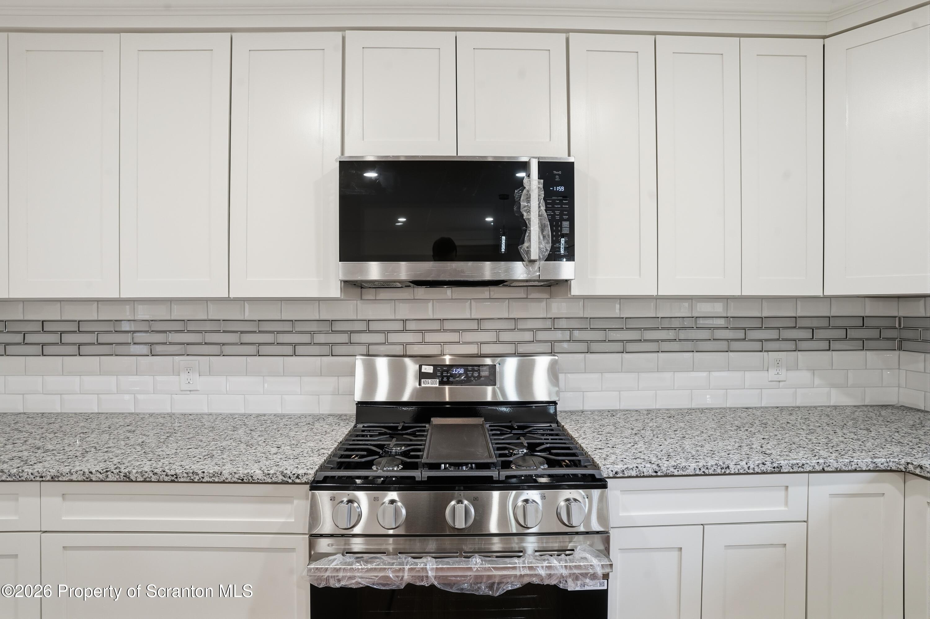 16204 Highway 407 Factoryville, PA 18419 - Photo 38 of 74 a stove top oven sitting inside of a kitchen