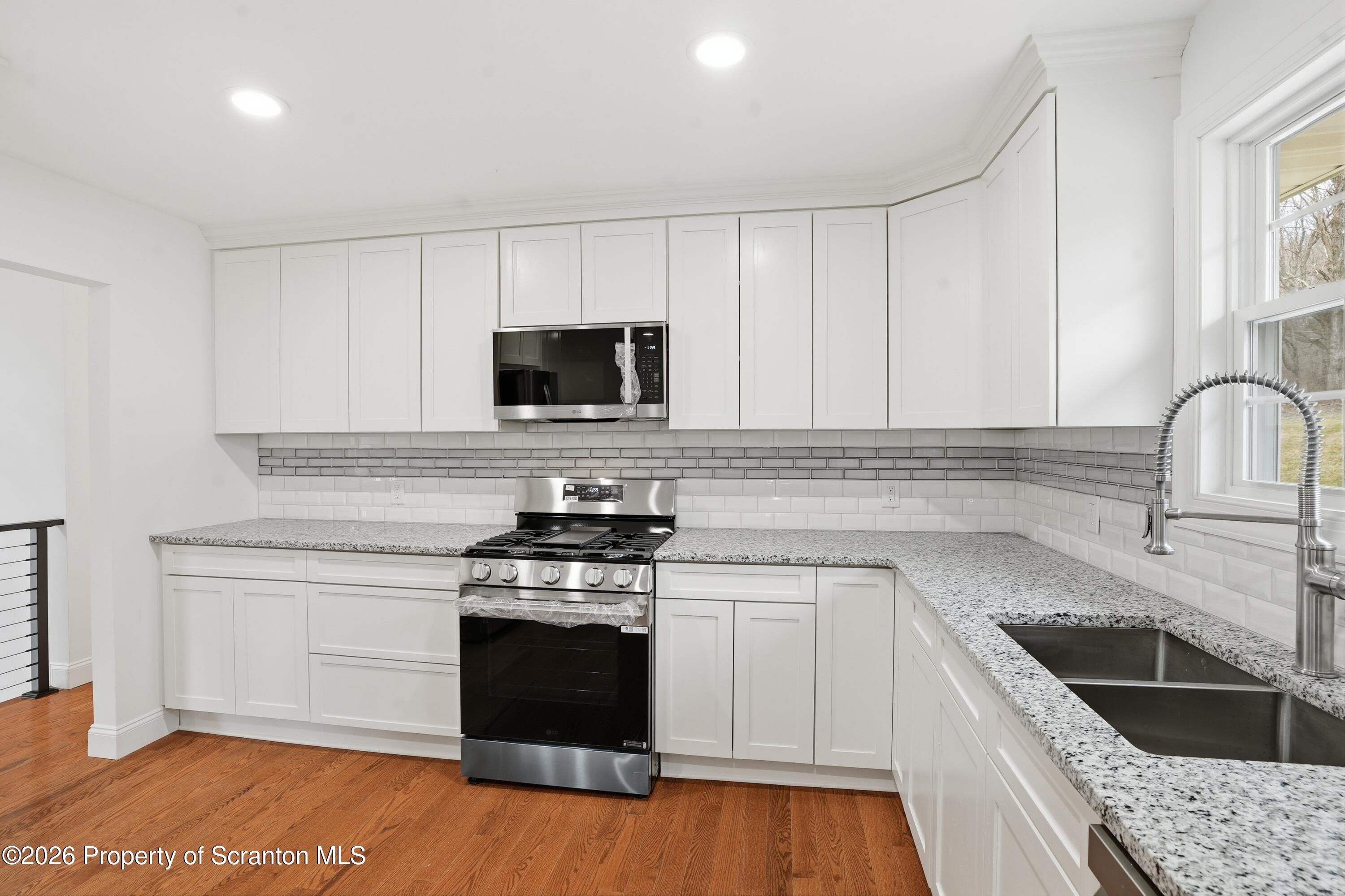 16204 Highway 407 Factoryville, PA 18419 - Photo 39 of 74 a kitchen with a sink stove and microwave