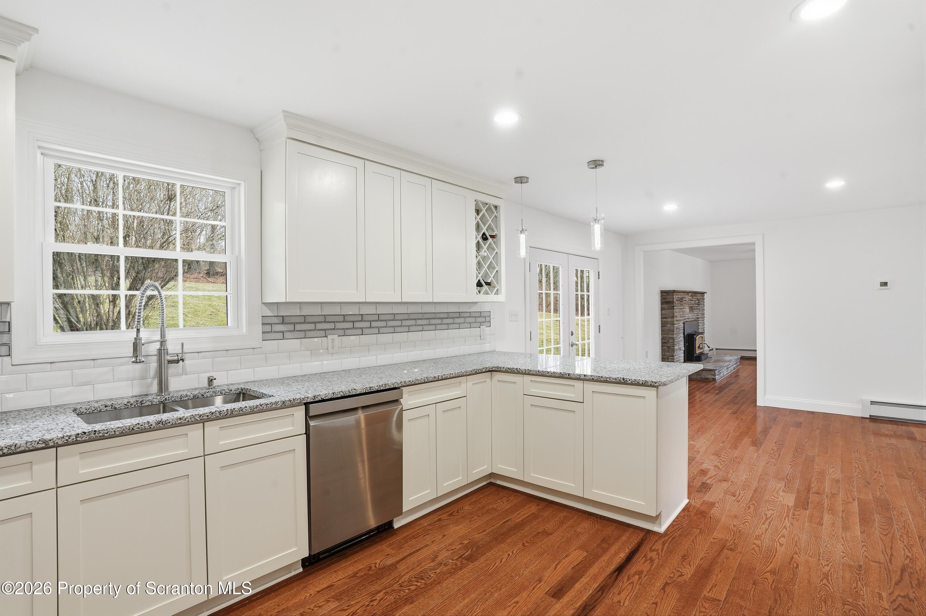 16204 Highway 407 Factoryville, PA 18419 - Photo 41 of 74 a kitchen with sink cabinets and wooden floor