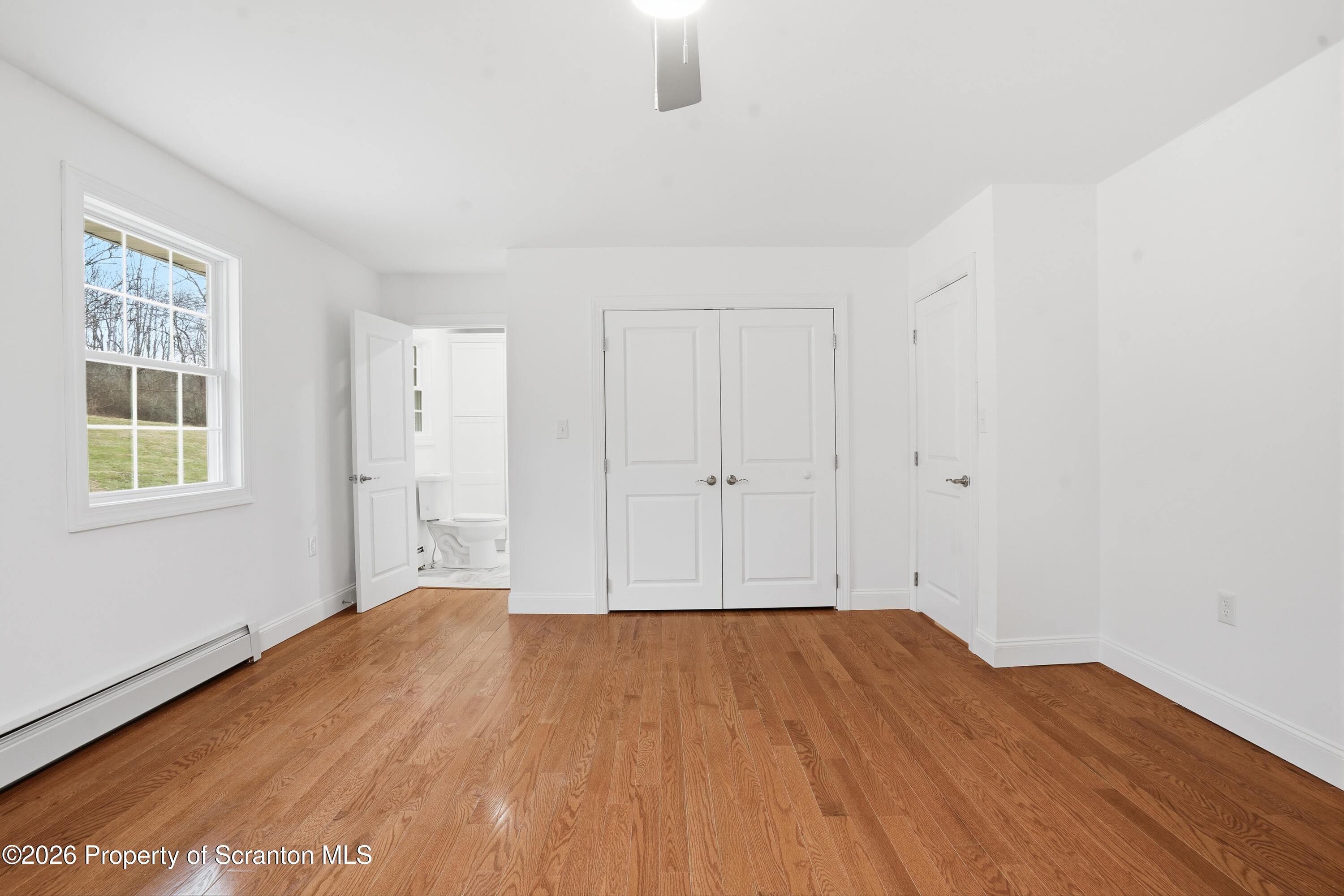 16204 Highway 407 Factoryville, PA 18419 - Photo 49 of 74 a view of empty room with wooden floor and fan