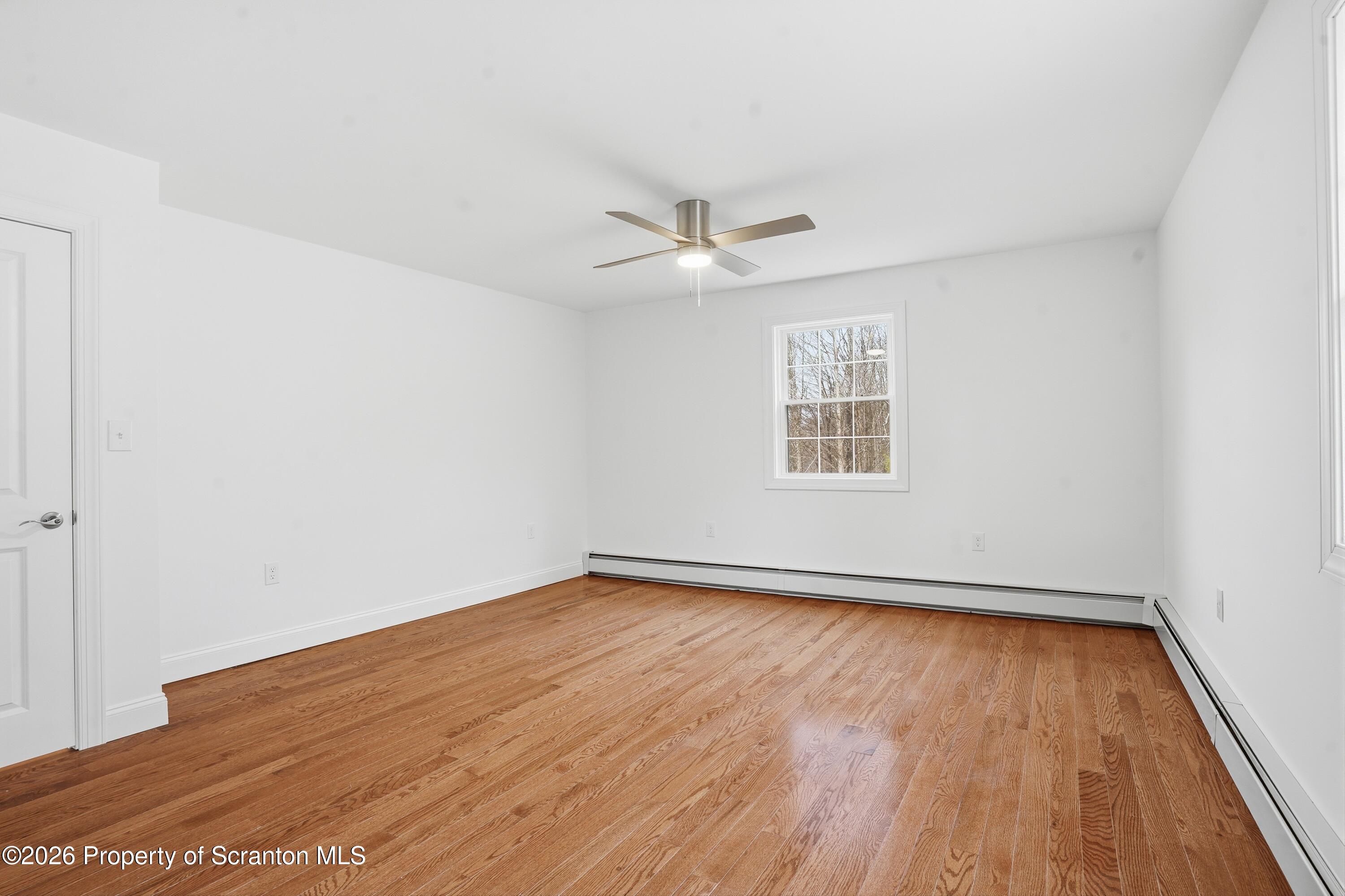 16204 Highway 407 Factoryville, PA 18419 - Photo 53 of 74 wooden floor in an empty room with a window