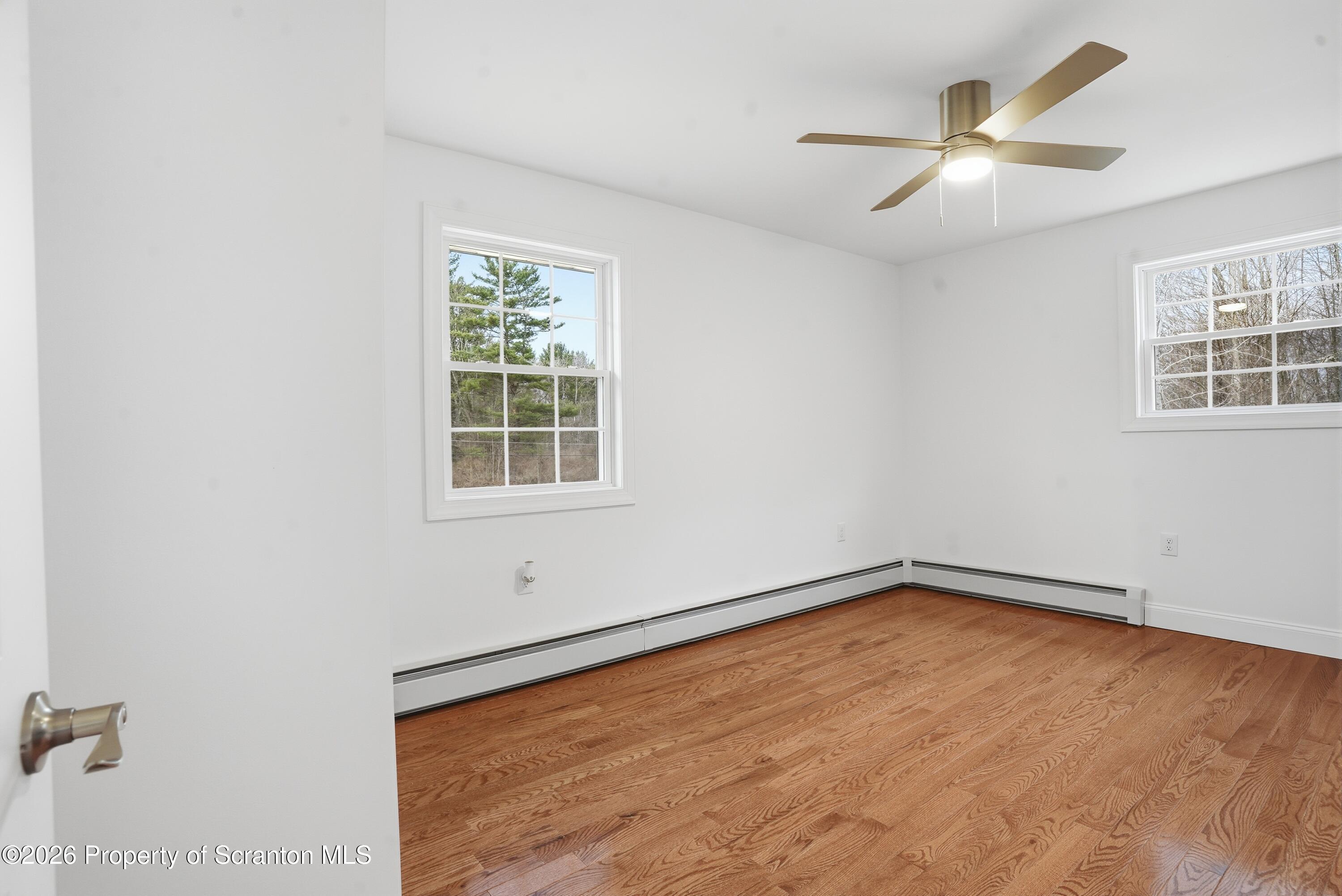 16204 Highway 407 Factoryville, PA 18419 - Photo 54 of 74 an empty room with windows and fan