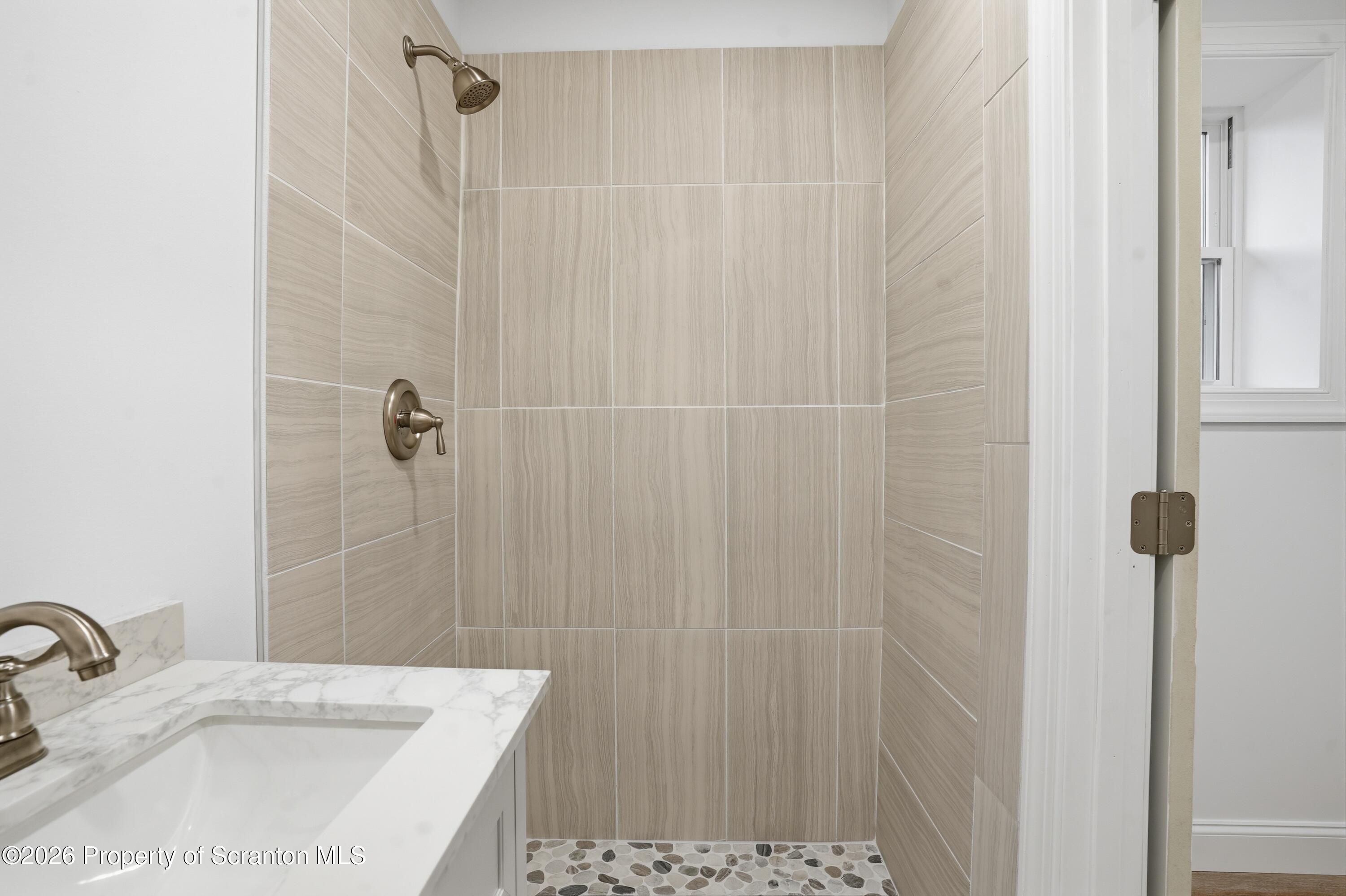 16204 Highway 407 Factoryville, PA 18419 - Photo 64 of 74 a bathroom with a sink a shower and a mirror