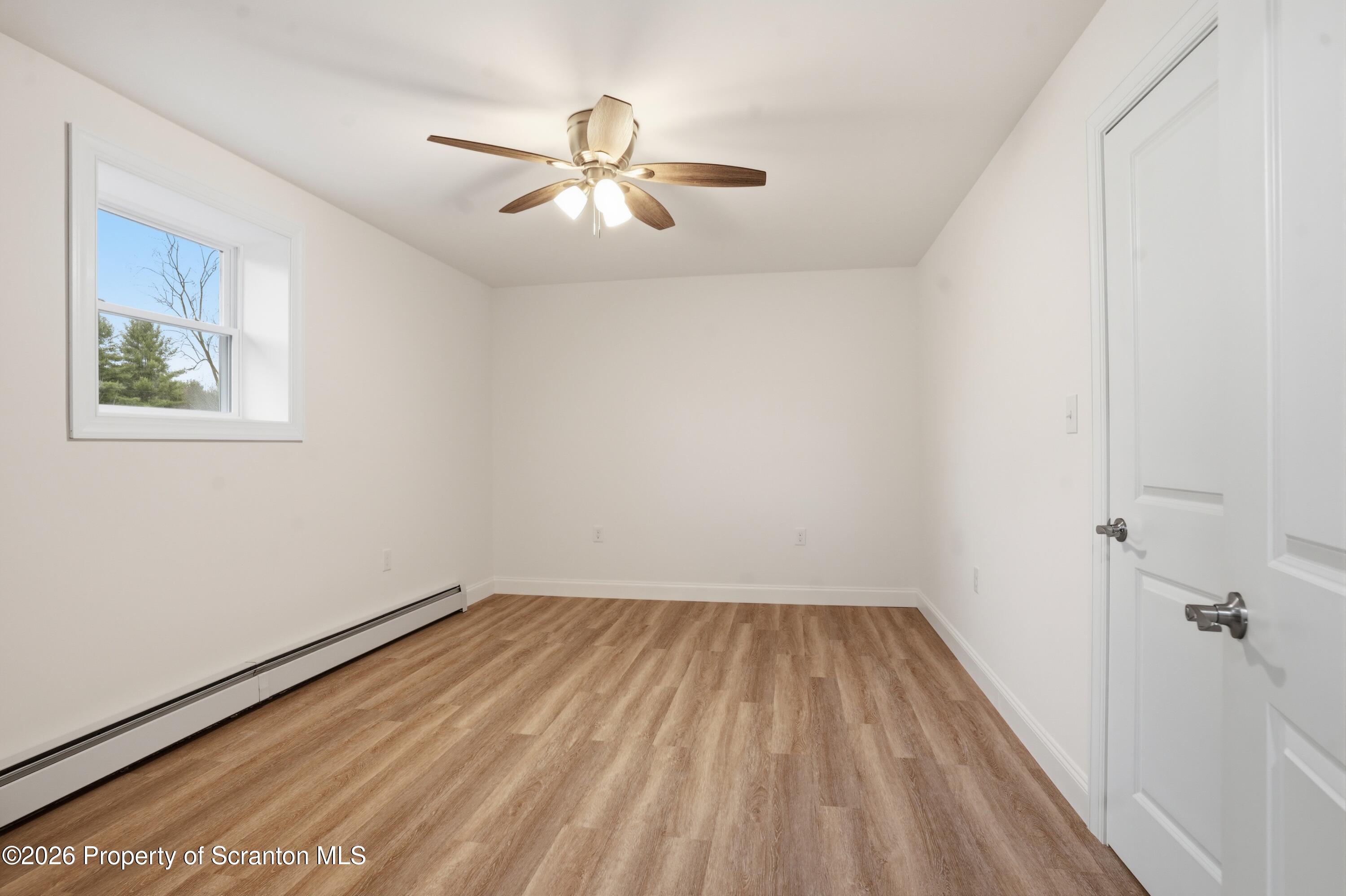 16204 Highway 407 Factoryville, PA 18419 - Photo 65 of 74 wooden floor in an empty room with a window