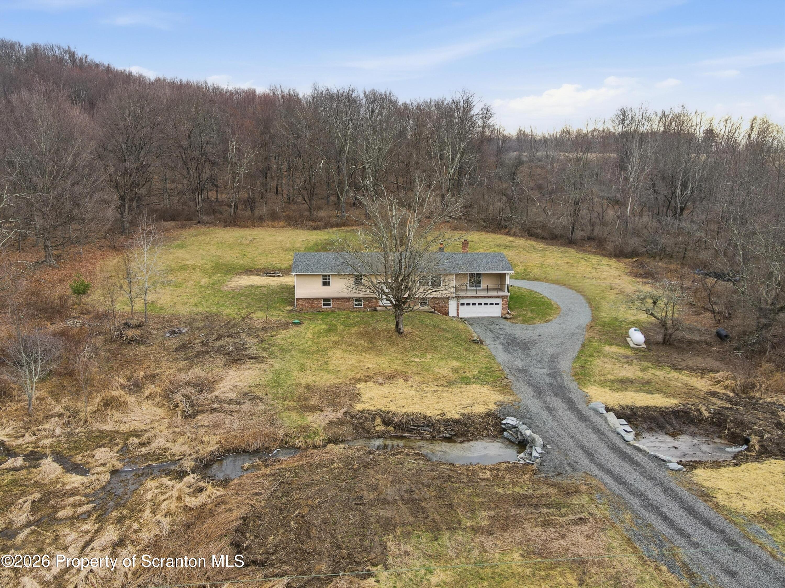 16204 Highway 407 Factoryville, PA 18419 - Photo 72 of 74 a view of a swimming pool with a yard and mountain view