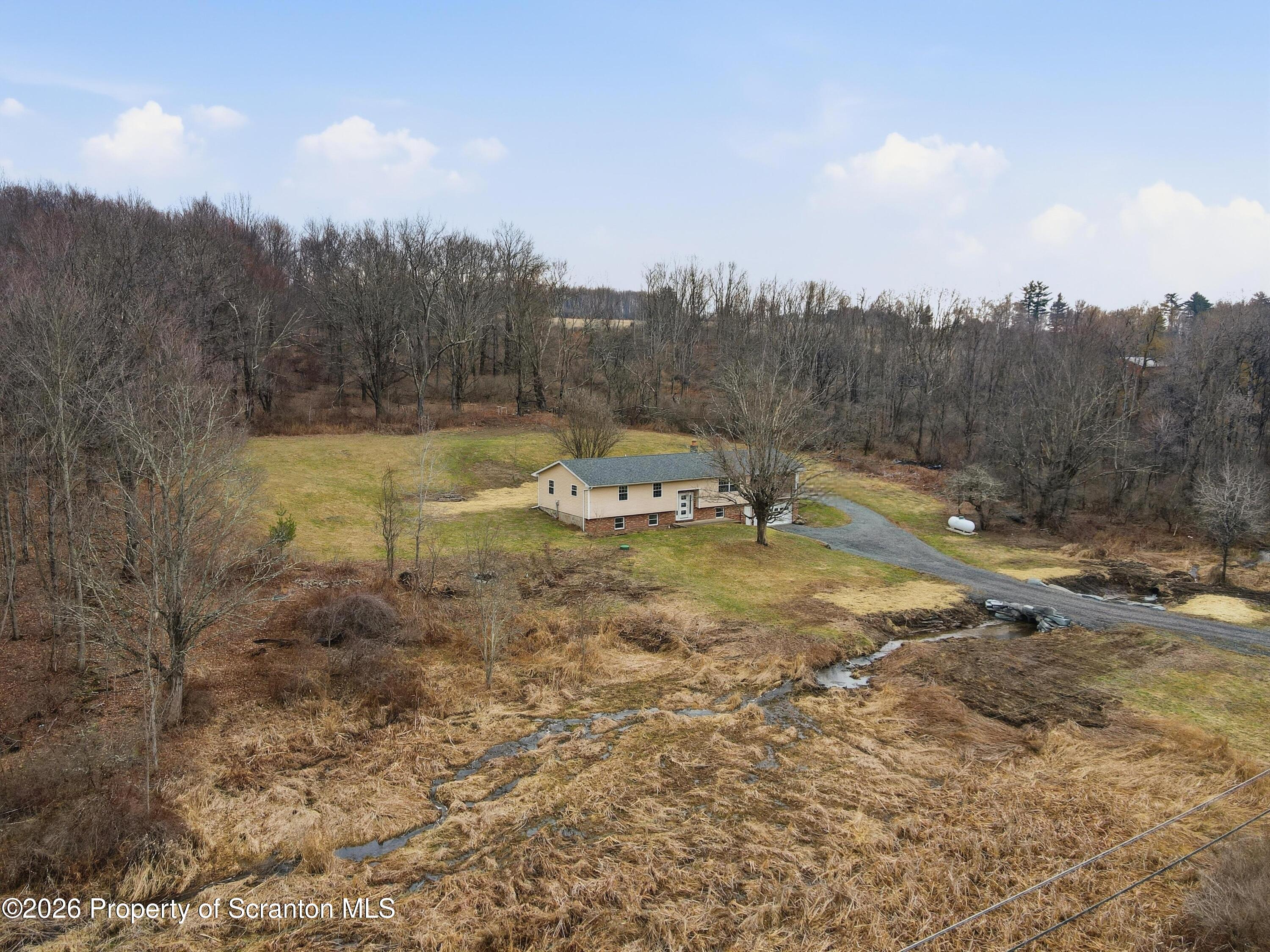 16204 Highway 407 Factoryville, PA 18419 - Photo 74 of 74 a view of outdoor space with green field and trees around