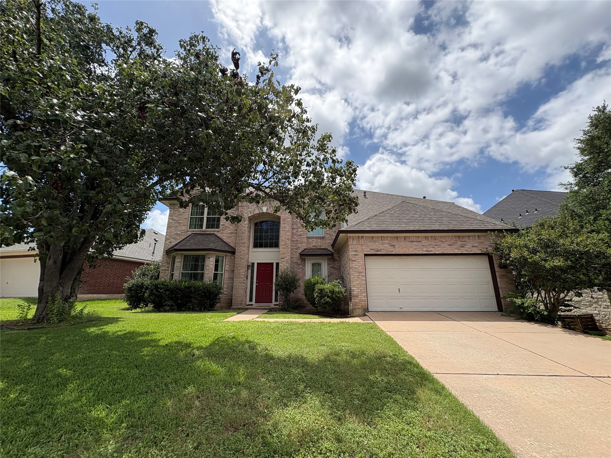 8103 Ephraim Road Austin, TX 78717 - Photo 2 of 35 A classic brick facade welcomes with a bright entry, leading to a spacious driveway.