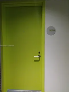 a bedroom with a bed and painting on the wall