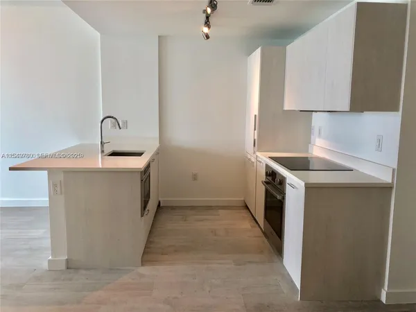 a kitchen with a sink stove and cabinets