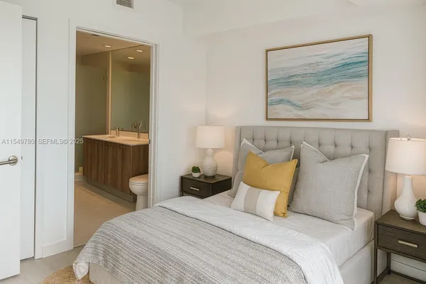a bedroom with a bed and a painting on the wall