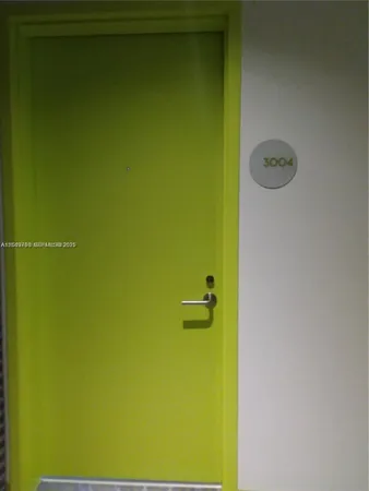 a bedroom with a bed and painting on the wall