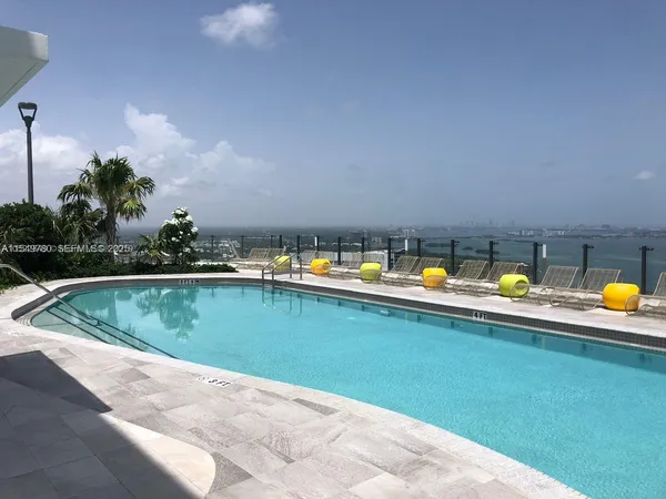 a swimming pool with trees in the background