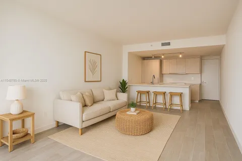 a living room with furniture a rug and a large window