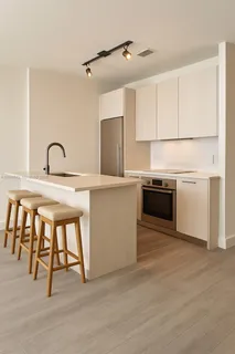 a kitchen with kitchen island a stove and a microwave