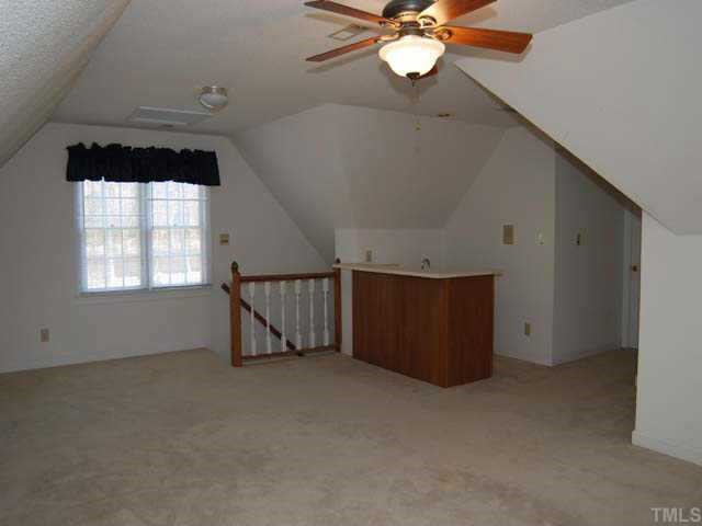 10808 Brass Kettle Road Raleigh, NC 27614 - Photo 10 of 12 A wonderful bonus room offers carpet, neutral wall paint, ceiling fan with light, overhead light, single and double widows with mini binds, wet bar, closet, dormer storage access and a back staircase Other