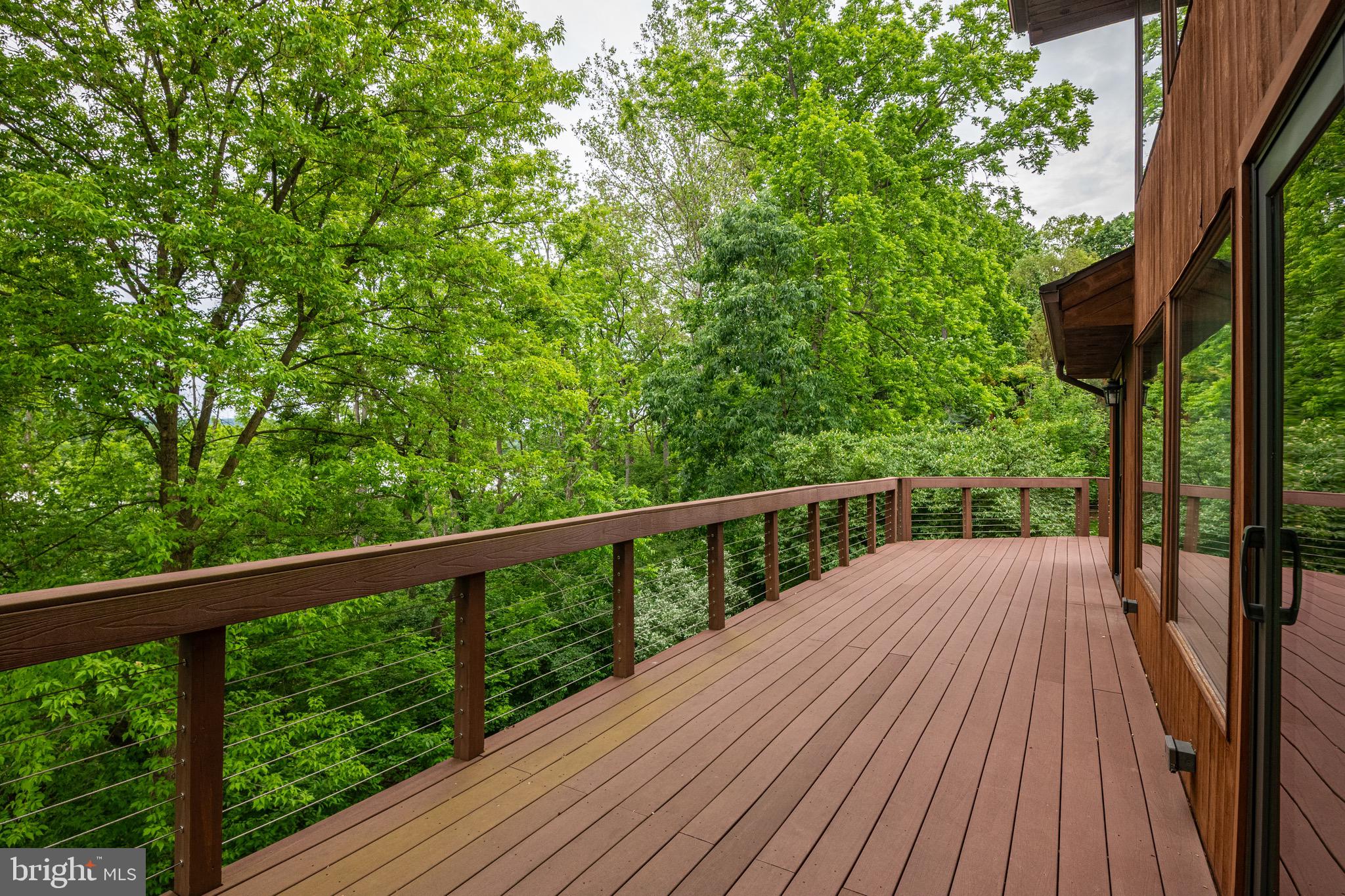 40 Golfview Lane Reading, PA 19606 - Photo 7 of 48 a balcony with wooden floor and trees in the back