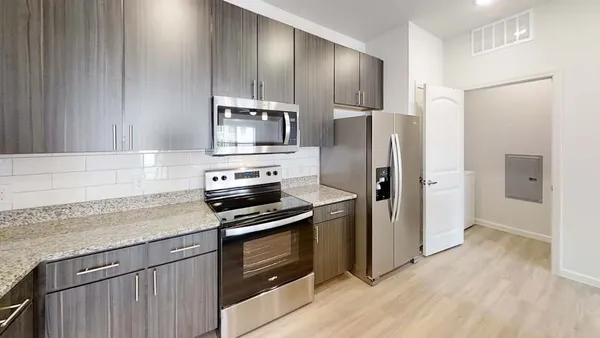 a kitchen with granite countertop a sink and cabinets