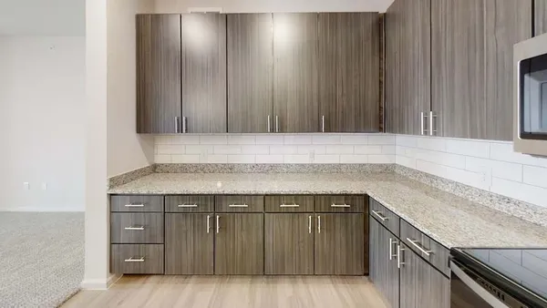 a view of kitchen with kitchen island a sink a stove and refrigerator
