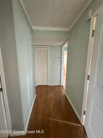 an empty room with windows and entrance