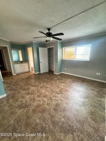 a view of a room with wooden floor and windows