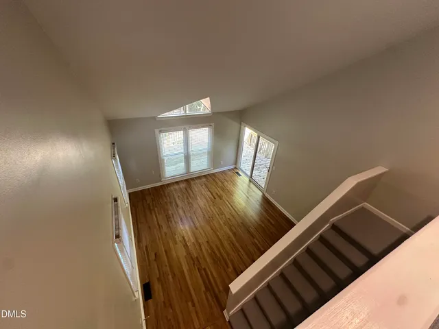 a view of an empty room and wooden floor