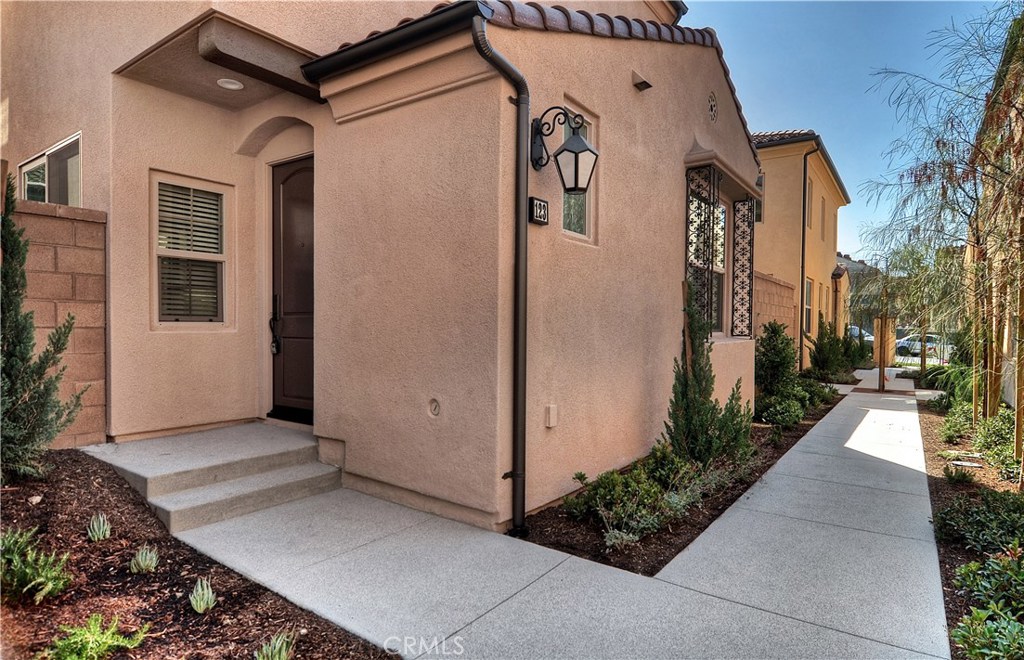 123 Quiet Grove Irvine, CA 92618 - Photo 1 of 16 a view of a house with backyard and garden