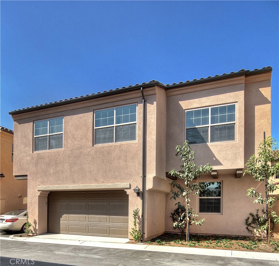 123 Quiet Grove Irvine, CA 92618 - Photo 11 of 16 a front view of a house with a yard
