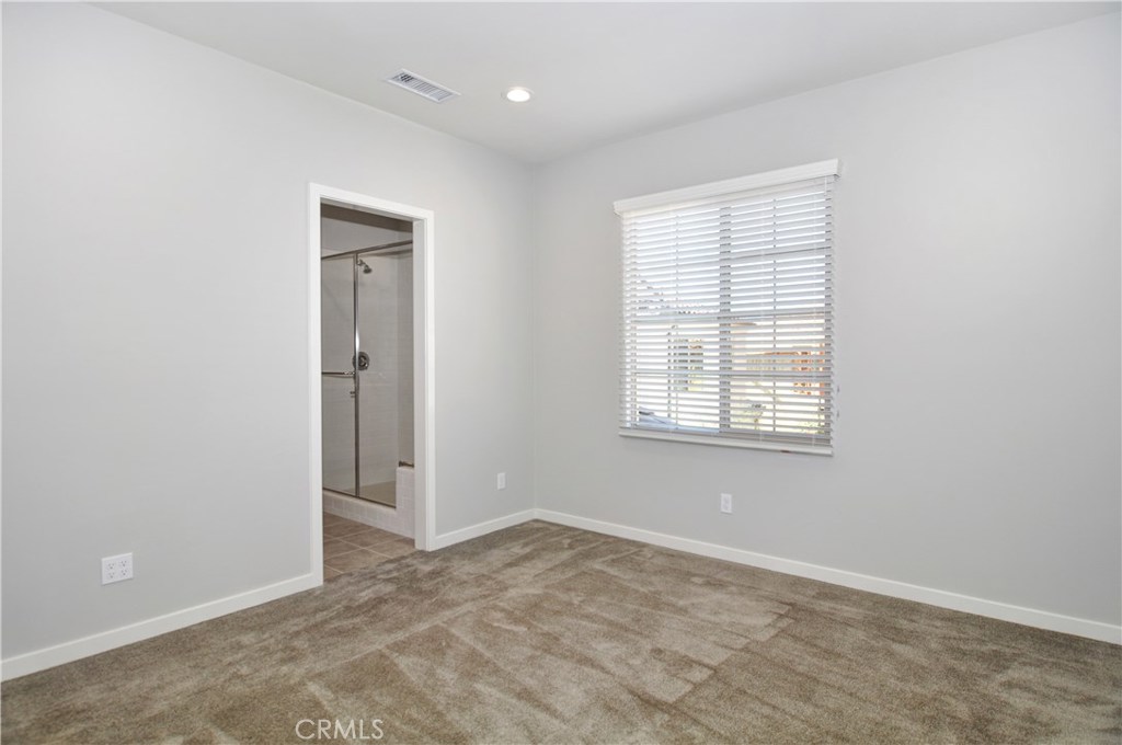 123 Quiet Grove Irvine, CA 92618 - Photo 8 of 16 an empty room with windows and closet