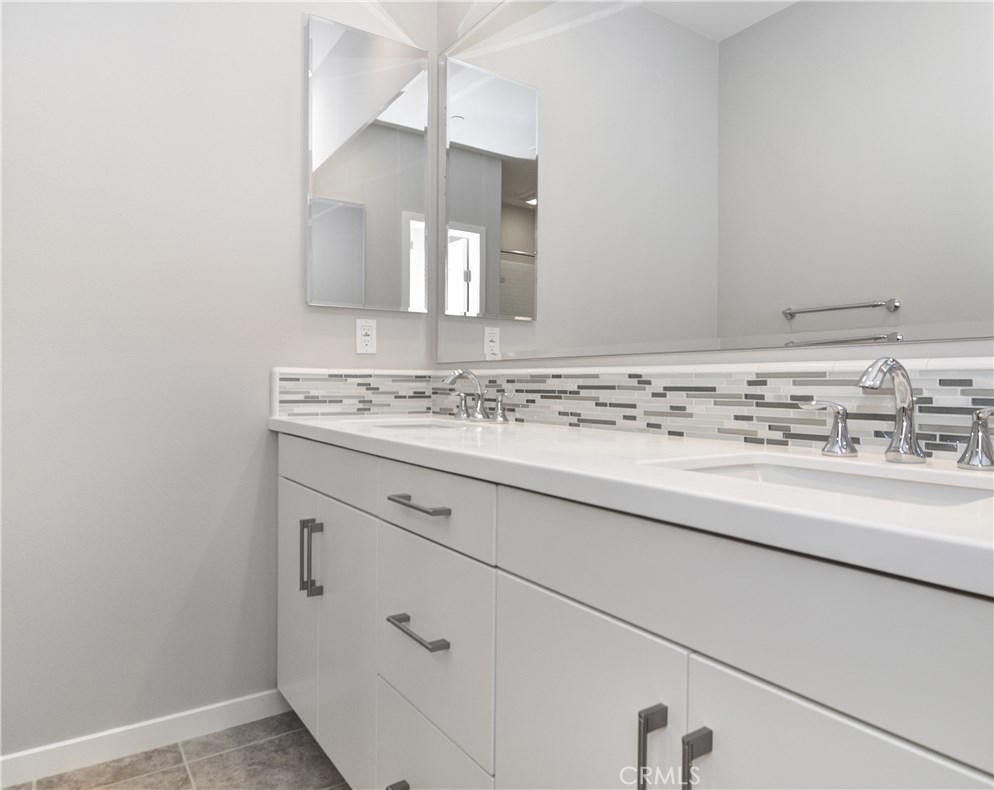 123 Quiet Grove Irvine, CA 92618 - Photo 9 of 16 a bathroom with a sink and a mirror