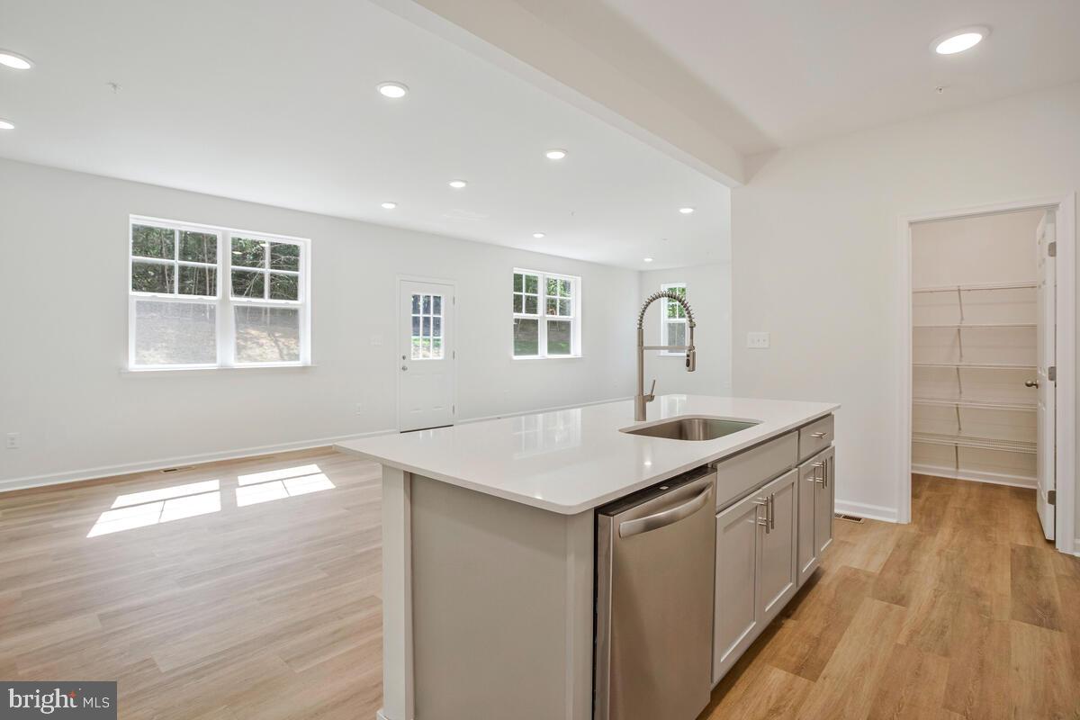 900 Walnut Avenue North Beach, MD 20714 - Photo 16 of 82 a kitchen with a sink dishwasher and wooden floor