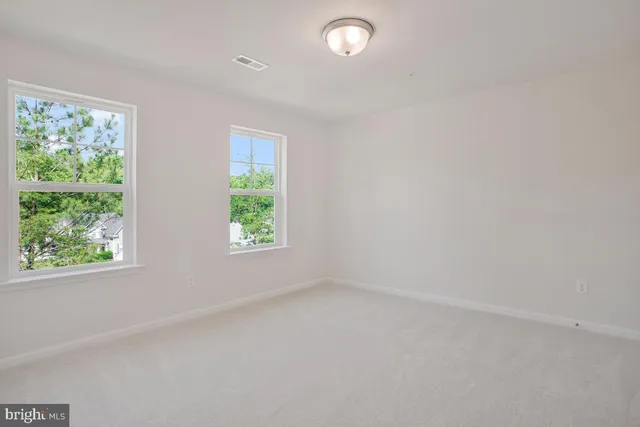 a bathroom with double vanity and a mirror