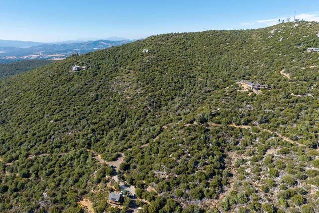 a view of a large building with mountains in the background