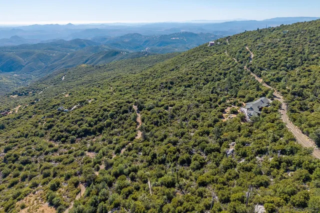 a view of a field with a mountain in the background