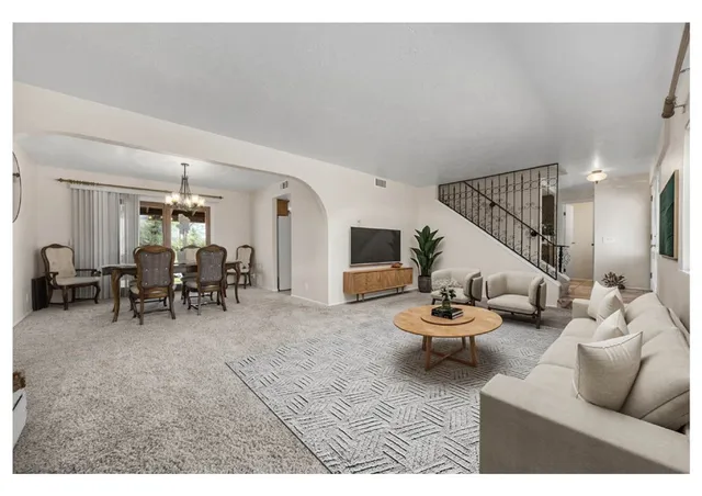 a living room with furniture and white walls